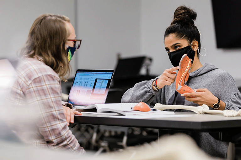 An IUPUI teacher uses anatomical models to instruct their student