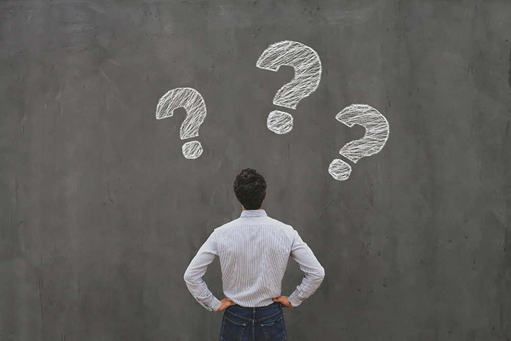 stock photo of guy looking at three question marks
